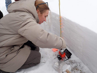 Senior Researcher V.A. Lobkina conducts in-situ observation of seasonal stratified snow cover